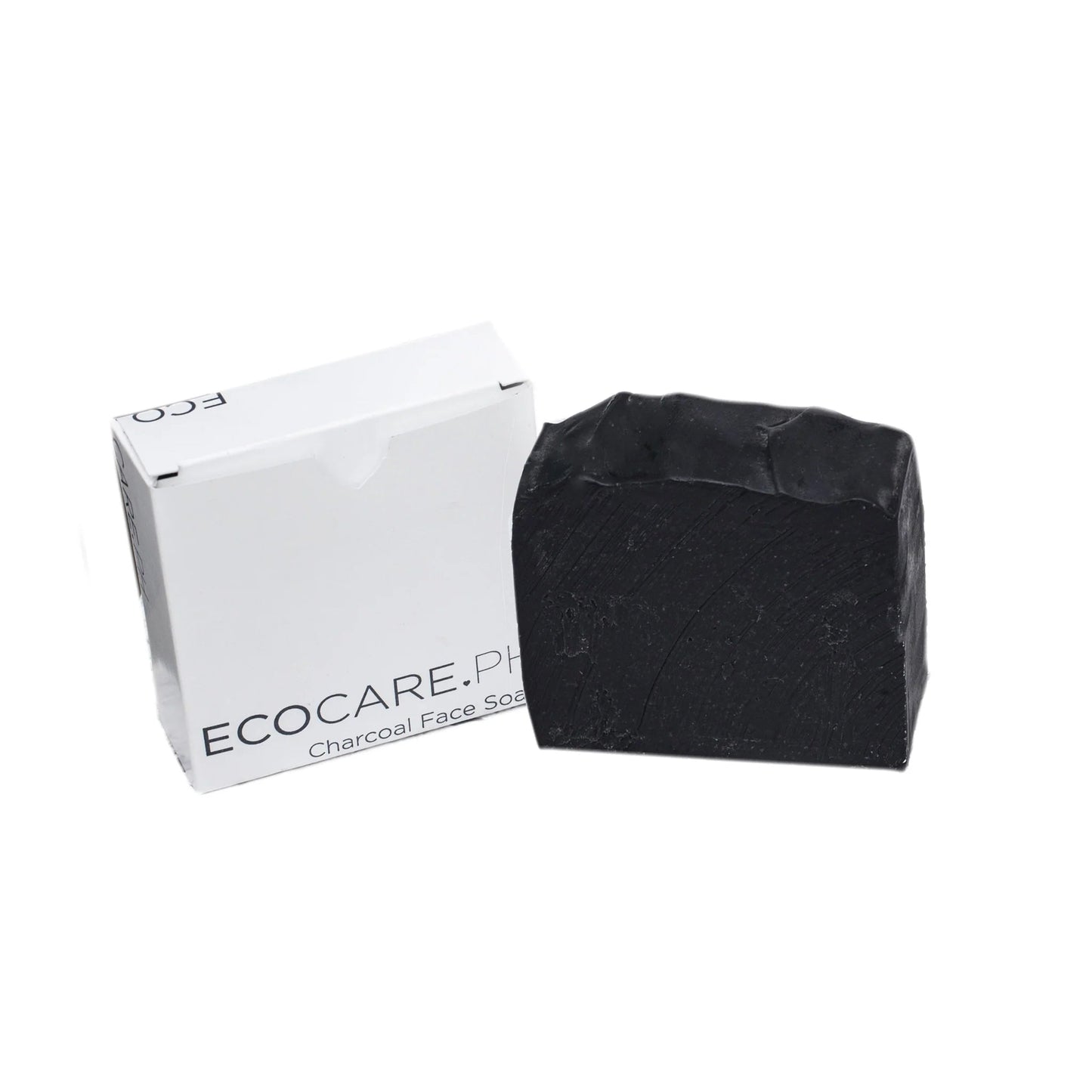 Charcoal soap bar and white box, angled view with black soap surface texture