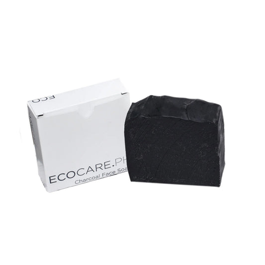 Charcoal soap bar and white box, angled view with black soap surface texture